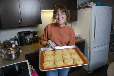 Henegar Holds a freshly baked batch of cookies